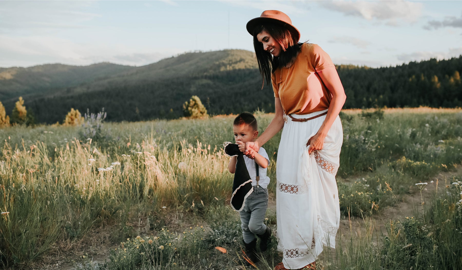 picture of a mom and little boy in fall outfits in a field